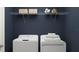 Bright laundry room featuring a white washer and dryer, and built-in shelving at 13510 White Gold Run, Parrish, FL 34219