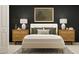 Modern bedroom featuring a bed with decorative pillows, matching nightstands and neutral carpet at 13526 White Gold Run, Parrish, FL 34219