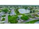 Aerial view of a residential area with homes surrounding a tranquil lake, showcasing a peaceful community at 1417 Langley Dr, Sun City Center, FL 33573