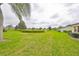 Expansive backyard with views of the neighborhood pond, providing a peaceful and scenic outdoor retreat at 1417 Langley Dr, Sun City Center, FL 33573