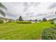 Serene backyard overlooking a picturesque pond and lush landscaping for tranquil outdoor living at 1417 Langley Dr, Sun City Center, FL 33573