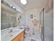 Bright bathroom features tile flooring, sleek vanity, and glass shower, offering a modern retreat at 1417 Langley Dr, Sun City Center, FL 33573