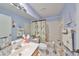 Well-lit bathroom with tile floors, shower and tub combo for ultimate convenience at 1417 Langley Dr, Sun City Center, FL 33573