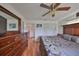 Cozy bedroom with a ceiling fan, hardwood floors and built in storage at 1417 Langley Dr, Sun City Center, FL 33573