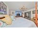 Bright bedroom featuring a four poster bed, ceiling fan, and sliding glass doors to the lanai at 1417 Langley Dr, Sun City Center, FL 33573