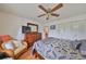 Comfortable bedroom with ceiling fan, and chair for relaxation, creating a serene retreat at 1417 Langley Dr, Sun City Center, FL 33573
