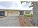 Charming home with well-kept landscaping, attached garage, and inviting curb appeal in a friendly neighborhood at 1417 Langley Dr, Sun City Center, FL 33573