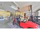 Bright garage features a parked golf cart, laundry area, and pegboard organizers, perfect for hobbyists at 1417 Langley Dr, Sun City Center, FL 33573