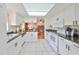 Charming kitchen featuring crisp white cabinetry and modern appliances, providing a delightful culinary atmosphere at 1417 Langley Dr, Sun City Center, FL 33573