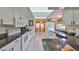 Bright kitchen featuring white cabinetry, granite countertops, and modern appliances, creating a clean and functional space at 1417 Langley Dr, Sun City Center, FL 33573