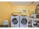 Spacious laundry room equipped with modern washing machines, offering convenience for household tasks at 1417 Langley Dr, Sun City Center, FL 33573