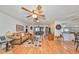 Spacious living room with wood flooring, ceiling fan, and comfortable seating at 1417 Langley Dr, Sun City Center, FL 33573