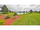 Scenic view of a tranquil pond surrounded by lush greenery and manicured landscaping at 1417 Langley Dr, Sun City Center, FL 33573