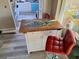 Kitchen island with a unique painted top and red stool in the kitchen at 1726 Massachusetts Ne Ave, St Petersburg, FL 33703