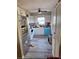Updated kitchen with stainless steel refrigerator, gray floors and white cabinets at 1726 Massachusetts Ne Ave, St Petersburg, FL 33703