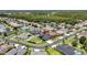 Aerial view of neighborhood homes and a blue house featuring a large backyard at 1741 Beaconsfield Dr, Wesley Chapel, FL 33543
