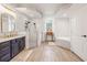 Modern bathroom boasting a large walk-in shower, dual vanity sinks, and soaking tub at 1741 Beaconsfield Dr, Wesley Chapel, FL 33543