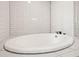 Elegant bathroom featuring a large soaking tub and white subway tile at 1741 Beaconsfield Dr, Wesley Chapel, FL 33543