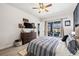 Primary bedroom with outside views, ceiling fan, and tiled floors leading out to the pool at 1741 Beaconsfield Dr, Wesley Chapel, FL 33543