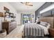 Primary bedroom with outside views, ceiling fan, and tiled floors leading out to the pool at 1741 Beaconsfield Dr, Wesley Chapel, FL 33543