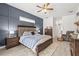 Well appointed primary bedroom with a decorative wall accent, a ceiling fan, and tile flooring at 1741 Beaconsfield Dr, Wesley Chapel, FL 33543