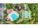 A top-down aerial view of the community pool, basketball courts, playground, and parking area at 1741 Beaconsfield Dr, Wesley Chapel, FL 33543