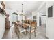 Elegant dining area with a long table, seating for ten, and an open layout into the living spaces at 1741 Beaconsfield Dr, Wesley Chapel, FL 33543