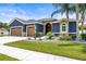 Stunning home with a beautifully landscaped yard, complemented by a two-car garage and elegant stone accents at 1741 Beaconsfield Dr, Wesley Chapel, FL 33543