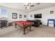 Spacious game room with a pool table, comfortable seating, and entertainment setup at 1741 Beaconsfield Dr, Wesley Chapel, FL 33543