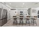 Modern kitchen with stainless steel appliances, a large island with seating, and bright white cabinetry at 1741 Beaconsfield Dr, Wesley Chapel, FL 33543