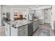 Expansive kitchen featuring a marble island, stainless steel appliances, and an open view to the dining area at 1741 Beaconsfield Dr, Wesley Chapel, FL 33543