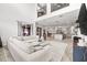 Open-concept living room with kitchen views, light gray flooring, and comfortable sectional sofa at 1741 Beaconsfield Dr, Wesley Chapel, FL 33543