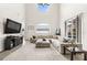 Bright living room boasts vaulted ceilings, a large sectional sofa, and access to the backyard at 1741 Beaconsfield Dr, Wesley Chapel, FL 33543