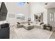 Bright living room boasts vaulted ceilings, a large sectional sofa, and a cozy, neutral color palette at 1741 Beaconsfield Dr, Wesley Chapel, FL 33543