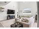 Bright living room boasts vaulted ceilings, a large sectional sofa, and a cozy, neutral color palette at 1741 Beaconsfield Dr, Wesley Chapel, FL 33543
