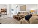 Open-concept living area with stylish sofas, a wooden coffee table, and seamless flow into the dining room at 1741 Beaconsfield Dr, Wesley Chapel, FL 33543