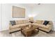 Cozy living room featuring neutral sofas, a rustic coffee table, and soft, inviting decor at 1741 Beaconsfield Dr, Wesley Chapel, FL 33543