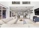 Open-concept living room with kitchen views, light gray flooring, and comfortable sectional sofa at 1741 Beaconsfield Dr, Wesley Chapel, FL 33543