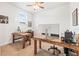 Functional home office with two wooden desks, a bright window, and neutral decor at 1741 Beaconsfield Dr, Wesley Chapel, FL 33543