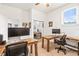 Well-lit home office with natural wood desks, comfortable chairs, and ample workspace at 1741 Beaconsfield Dr, Wesley Chapel, FL 33543