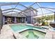 The home has a pool and hot tub that are screened in, as well as outdoor furniture at 1741 Beaconsfield Dr, Wesley Chapel, FL 33543