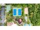 Bird's eye view showcasing tennis courts, a playground, sand volleyball and basketball court surrounded by green trees at 1741 Beaconsfield Dr, Wesley Chapel, FL 33543