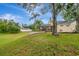 Expansive backyard featuring lush greenery, mature trees, and a screened-in lanai, perfect for enjoying the outdoors at 1808 Sawhorse Ct, Lutz, FL 33559