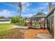 An inviting backyard with a screened-in pool enclosure, landscaped planters, and a well-maintained lawn, ideal for relaxation at 1808 Sawhorse Ct, Lutz, FL 33559