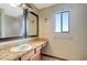 Bathroom featuring a long vanity with tan countertops, framed mirrors, and a window for natural light at 1808 Sawhorse Ct, Lutz, FL 33559