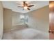 Bedroom with neutral carpet, a ceiling fan, and a window seat providing a cozy and bright space at 1808 Sawhorse Ct, Lutz, FL 33559