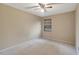 Bedroom featuring neutral carpet, a ceiling fan, and a window with blinds for adjustable light control at 1808 Sawhorse Ct, Lutz, FL 33559