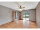 Spacious bedroom with wood floors, ceiling fan, and sliding glass door leading to the outdoor pool at 1808 Sawhorse Ct, Lutz, FL 33559