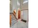 Welcoming foyer with tile floors, staircase, coat closet, and front door with sidelight at 1808 Sawhorse Ct, Lutz, FL 33559