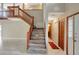 Bright foyer with staircase, tile floors, and coat closet provides a welcoming entrance at 1808 Sawhorse Ct, Lutz, FL 33559